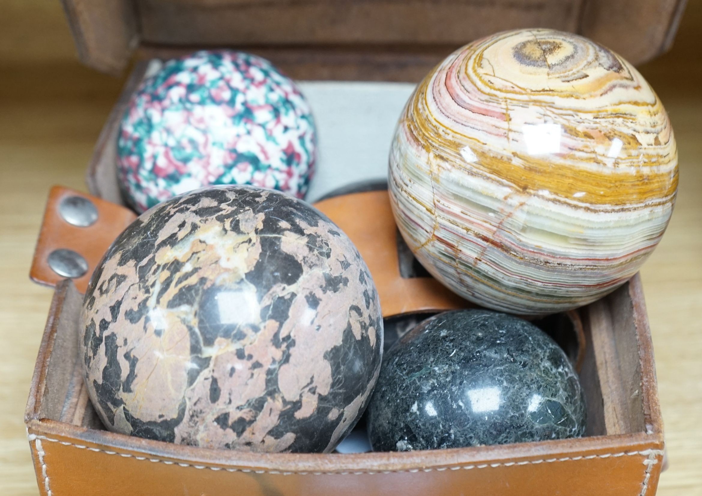 A collection of polished semi-precious stone eggs and balls